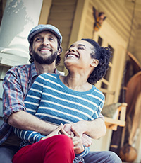 young couple laughing on porch